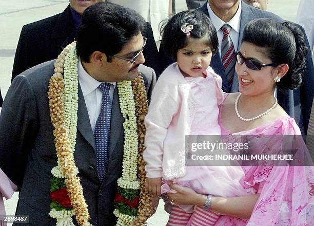 Nepal's Crown Prince Paras Bir Bikram Shah Dev speaks with his daughter Purnika and Princess Himani Rajyalakshmi Dev as they walk towards their car...