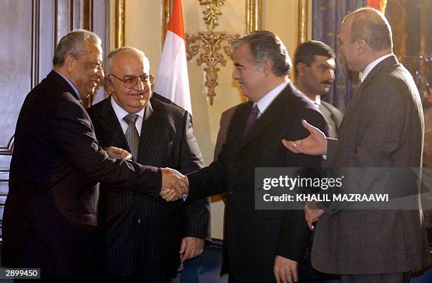 Lebanese Prime Minister Rafiq Hariri shakes hands with his Egyptian counterpart Atef Ebeid as Syrian Prime Minister Mohammed Naji al-Otri and...