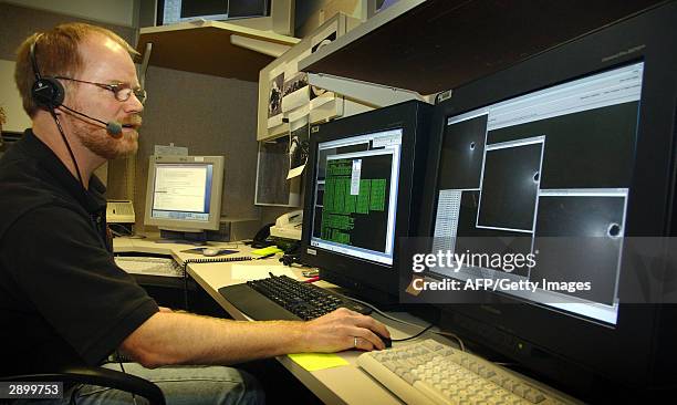 Reg Willson, engineer, Descent Image Motion Estimation Subsystem , reviews the DIMES images as they are received from the NASA Mars Rover Opportunity...