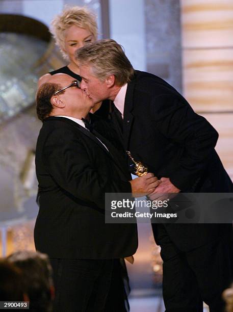 Actor/Director Danny De Vito and Actress Sharon Stone present an award to Actor Michael Douglas on stage at the 61st Annual Golden Globe Awards on...
