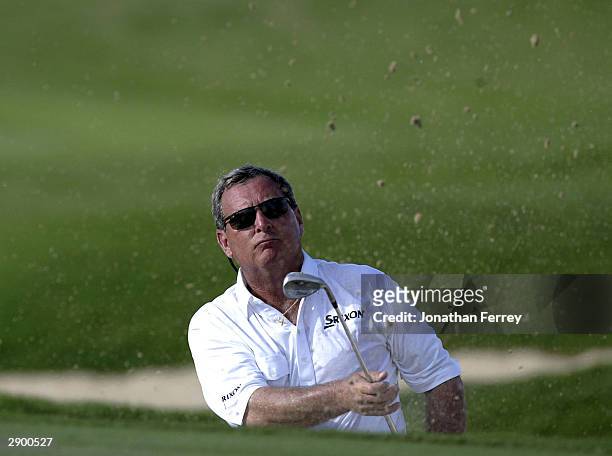 Fuzzy Zoeller watches his bunker shot onto the 14th hole during the first round of the Champions Tour Mastercard Championship on January 25, 2004 at...