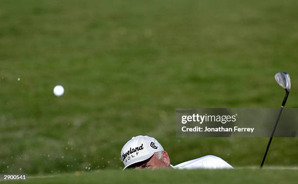 Doug Tewell eyes his ball out of the bunker on the 15th hole during the first round of the Champions Tour Mastercard Championship on January 25, 2004...