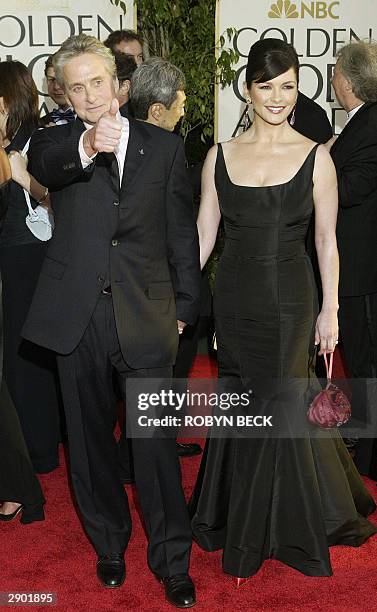 Actor Michael Douglas and his wife actress Catherine Zeta-Jones arrive for the Golden Globe Awards ceremony 25 January 2004, at the Beverly Hilton...