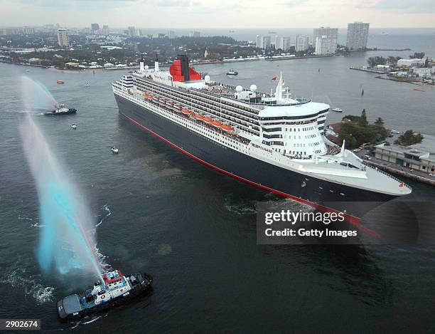 In this handout photo provided by Cunard Line, water-squirting tugboats salute the Queen Mary 2, the largest luxury ocean liner ever constructed, as...