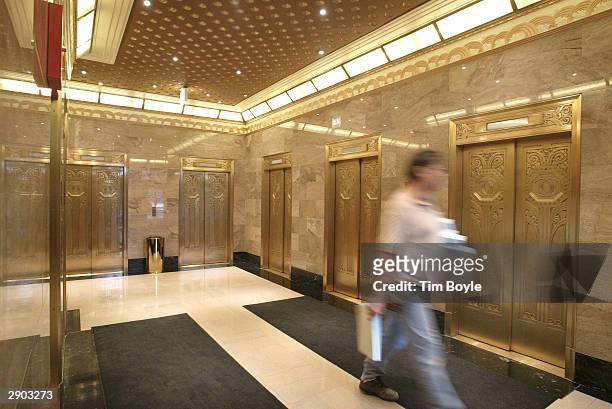 Worker walks past Art Deco-era elevators inside the new Hard Rock Hotel January 26, 2004 in Chicago, Illinois. Hard Rock Cafe International has...