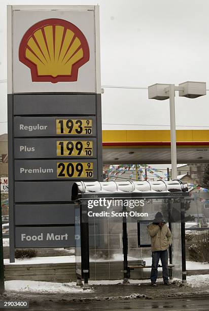 Sign towering over a bus stop advertises the price of gasoline at a gas station January 26, 2004 on the near north side of Chicago, Illinois. Prices...