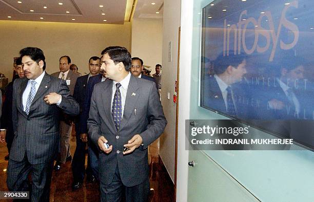 Nepalese Crown Prince Paras Bir Bikram Shah Dev is reflected on a company logo as he arrives at the headquarters of India's second largest software...