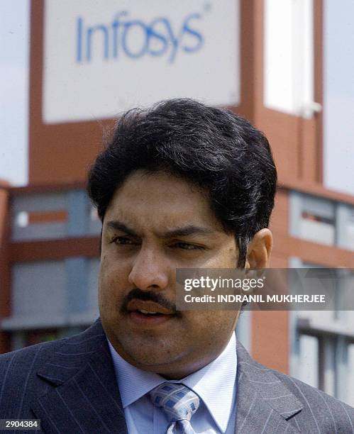 Nepalese Crown Prince Paras Bir Bikram Shah Dev speaks with an official during his visit to India's second largest software exporter Infosys...