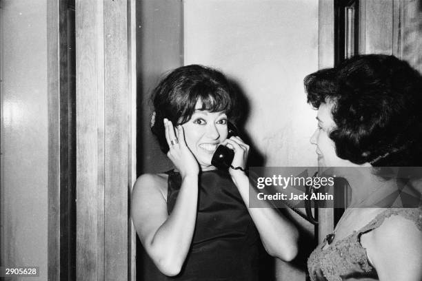 Puerto Rican actor Rita Moreno speaks on the telephone after winning the award for 'Actress In a Supporting Role' for the film 'Westside Story',...