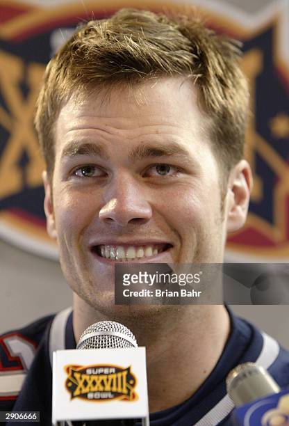 Quarterback Tom Brady of the New England Patriots smiles as he answers questions on media day January 26, 2003 before Super Bowl XXXVIII against the...