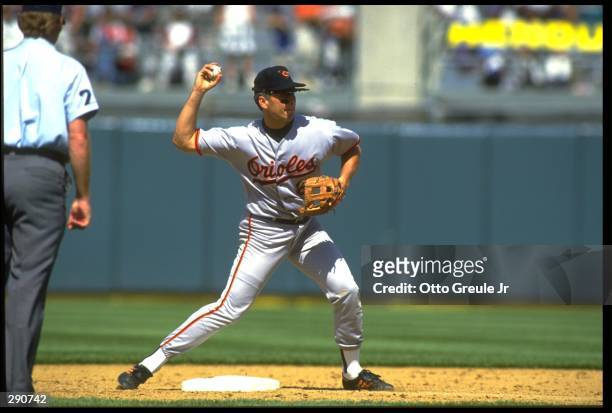 BALTIMORE ORIOLES SHORTSTOP CAL RIPKEN JR. ATTEMPTS TO TURN A DOUBLE PLAY DURING THE ORIOLES VERSUS OAKLAND ATHLETICS GAME AT THE OAKLAND COLISEUM IN...