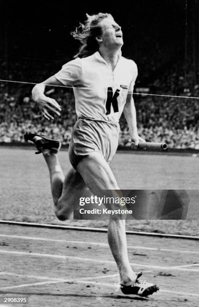 Fanny Blankers-Koen of the Netherlands in action on the anchor leg of the 4 x 100 metres relay during the 1948 Olympic Games at Wembley Stadium,...