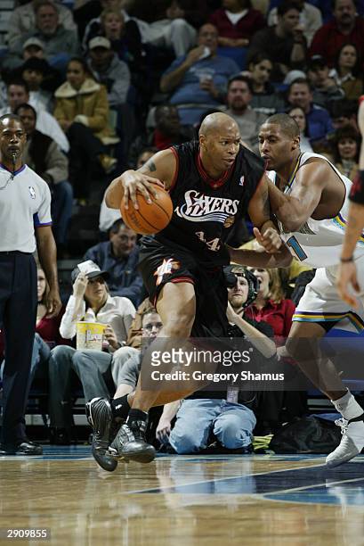 Derrick Coleman of the Philadelphia 76ers drives on Jamaal Magloire of the New Orleans Hornets during the game at the New Orleans Arena on January...