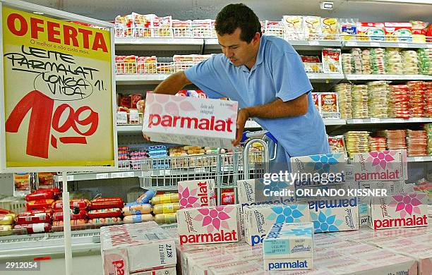 Man buys a Parmalat milk box at a supermarket on 29 January 2004 in Curitiba southern Brazil, with 50% discount. The Brazilian government called a...