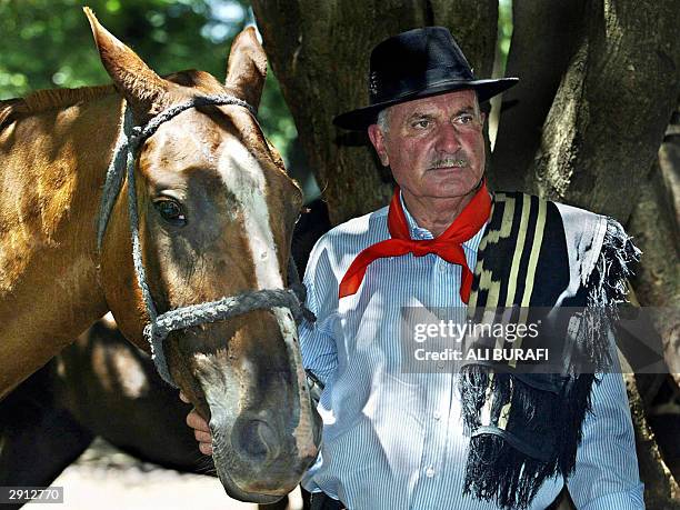 Gaucho "Coco" Ayala, who has been travelling all over Argentina conducting "jineteadas" for 34 years, poses with his horse in Carmen de Areco City,...