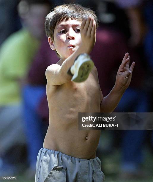 Boy plays knucklebones during the 'jineteadas' in Carmen de Areco City, in Buenos Aires province, Argentina, 25 January 2004. In the 'jineteadas'...