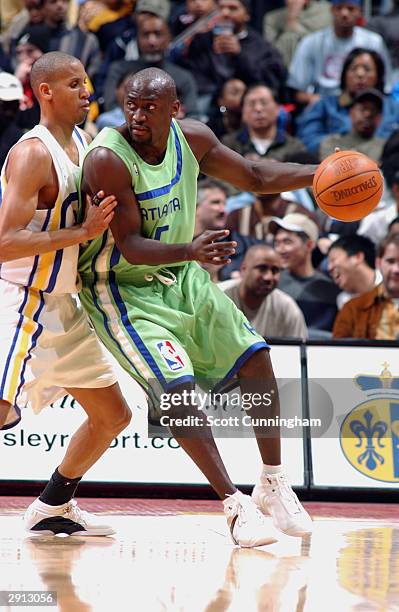 Dion Glover of the Atlanta Hawks is defended by Reggie Miller he Indiana Pacers during the game on January 19, 2004 at Philips Arena in Atlanta,...