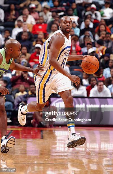 Anthony Johnson of the Indiana Pacers drives past Jacque Vaughn of the Atlanta Hawks during the game on January 19, 2004 at Philips Arena in Atlanta,...