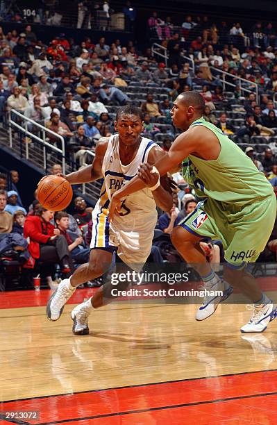 Ron Artest of the Indiana Pacers drives around Boris Diaw of the Atlanta Hawks during the game on January 19, 2004 at Philips Arena in Atlanta,...