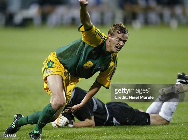 Ryan Griffiths of Australia celebrates scoring his goal as goalkeeper Glen Moss#1 of New Zealand lies on the ground during the Olympic Qualifying...