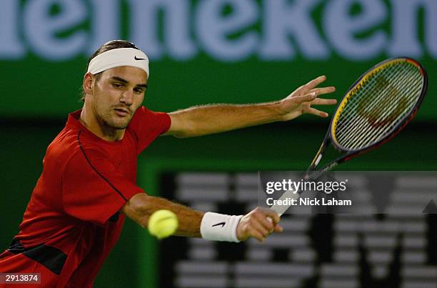 Roger Federer of Switzerland hits a backhand against Juan Carlos Ferrero of Spain during day twelve of the Australian Open Grand Slam at Melbourne...