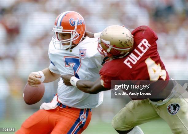 Quarterback Danny Wuerffel of the University of Florida fumbles the football after being hit by Corey Fuller of Florida State in Tallahassee,...