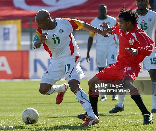 Senegal's El Hadji Diouf escapes Kenya's Emmanuel Ake Muttendago, 30 January 2004 in Bizerte, during their African Nations Cup group B match. Senegal...