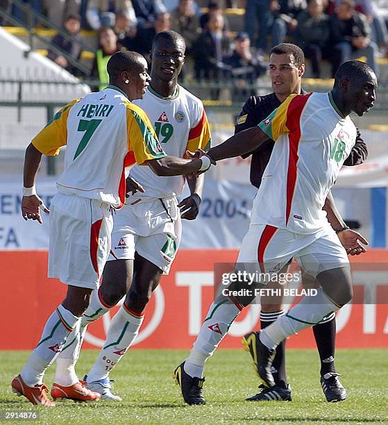 Senegal's Mamadou Niang is congratulated by teammates Henri Camara and Pape Bouba Diop, 30 January 2004 in Bizerte, during an African Nations Cup...