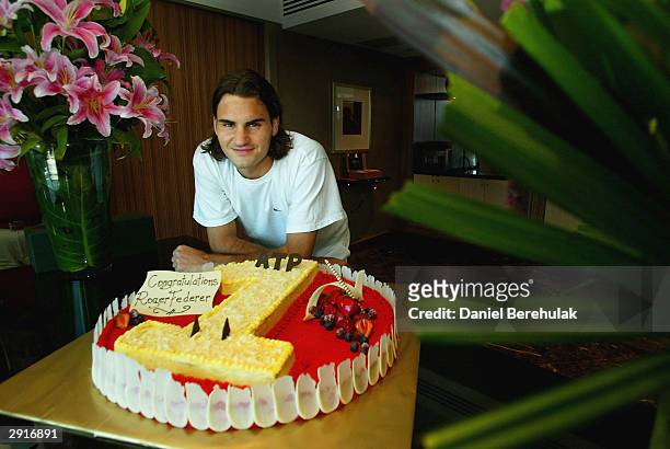 Roger Federer of Switzerland poses with a cake presented to him after becoming World Number One during day thirteen of the Australian Open Grand Slam...