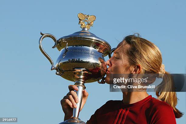 Justine Henin-Hardenne of Belgium poses with the Australian Open Trophy after her victory against Kim Clijsters of Belgium in the Womens Singles...