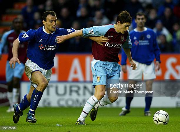 Nikos Dabizas of Leicester City tangles with Gareth Barry of Aston Villa during the FA Barclaycard Premiership match between Leicester City and Aston...