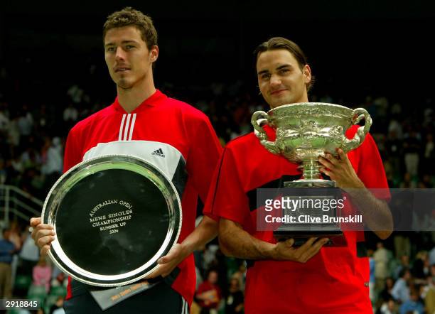 Marat Safin of Russia poses with Roger Federer of Switzerland after the Mens Singles Final during day fourteen of the Australian Open Grand Slam at...