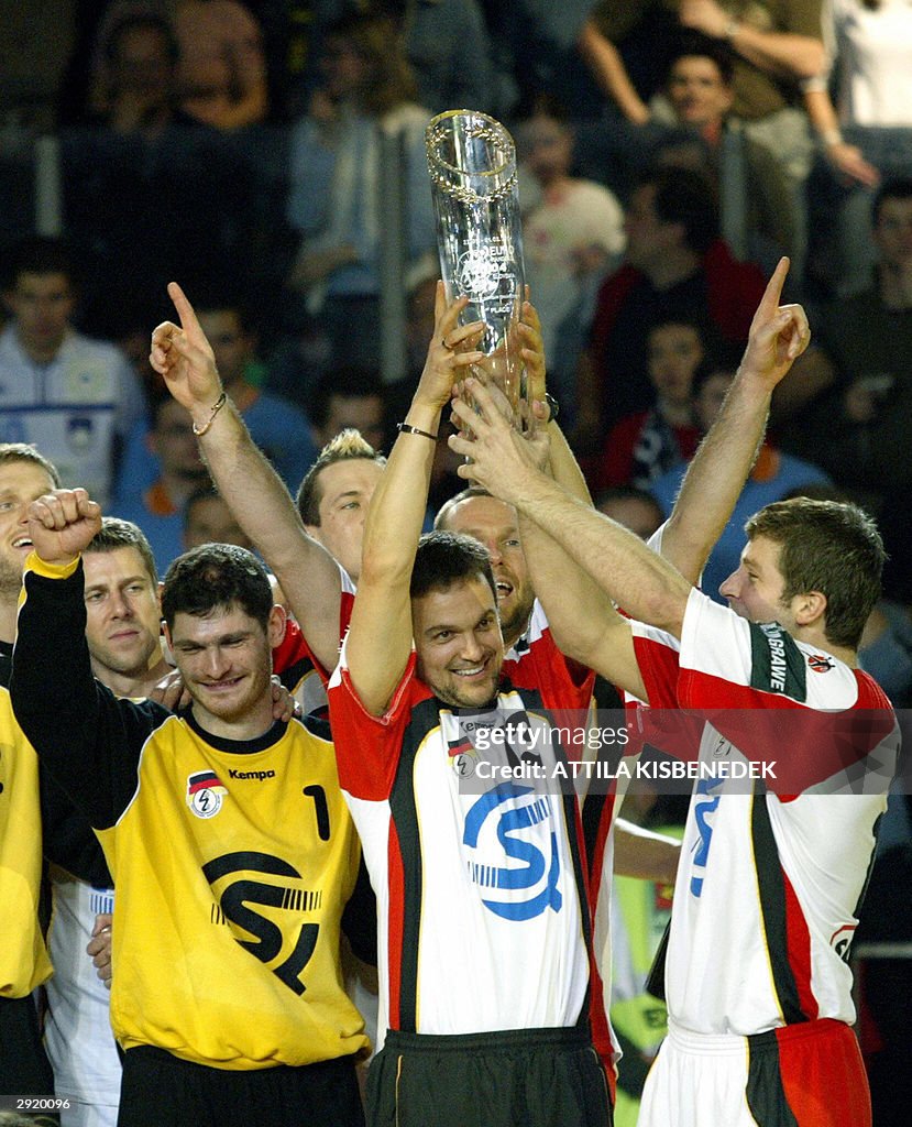 Germany's Markus Baur (C) lifts the trop