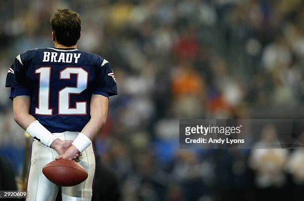 Quarterback Tom Brady of the New England Patriots looks on before Super Bowl XXXVIII against the Carolina Panthers at Reliant Stadium on February 1,...