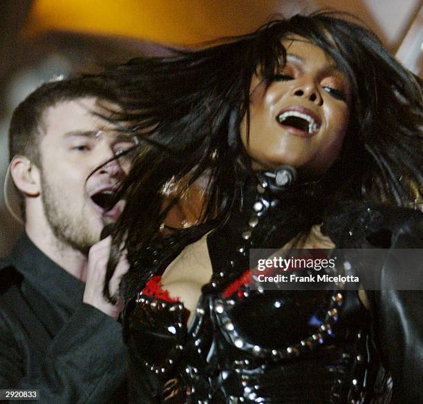 Singers Janet Jackson and surprise guest Justin Timberlake perform during the halftime show at Super Bowl XXXVIII between the New England Patriots...