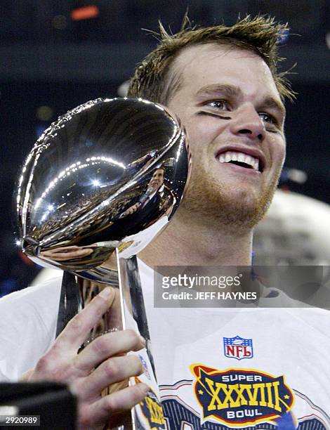 Quarterback Tom Brady of the New England Patriots holds the Vince Lombardi trophy after winning Super Bowl XXXVIII, 01 February 2004 at Reliant...