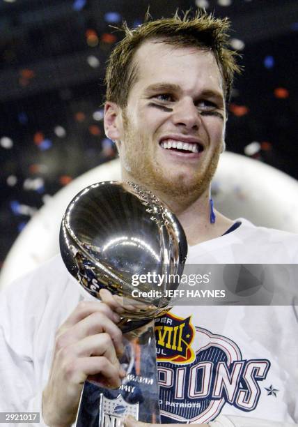 Quarterback Tom Brady of the New England Patriots holds the Vince Lombardi trophy after winning Super Bowl XXXVIII, 01 February, 2004 at Reliant...