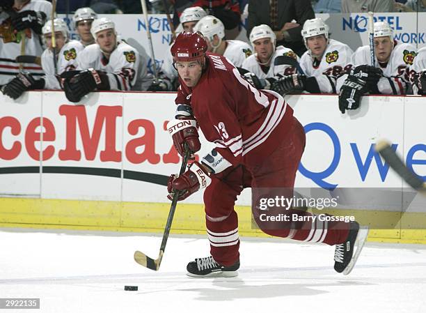 Paul Mara of the Phoenix Coyotes cycles the puck in the neutral zone against the Chicago Blackhawks on October 28, 2003 at America West Arena in...