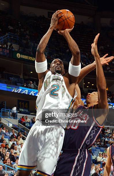 Stacy Augmon of the New Orleans Hornets shoots over Kerry Kittles of the New Jersey Nets on February 2, 2004 at the New Orleans Arena in New Orleans,...