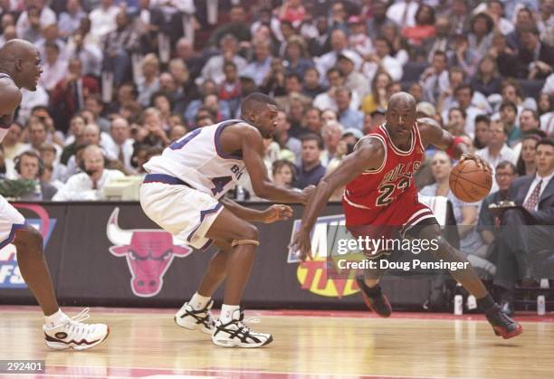 Guard Calbert Chaney of the Washington Bullets tries to guard guard Michael Jordan of the Chicago Bulls during a playoff game at the US Air Arena in...