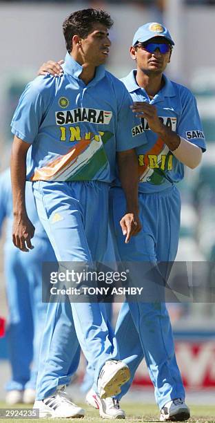 Indian fast bowler Ashish Nehra is congratulated by teammate Hemang Badani after taking the wicket of Zimbabwean Andy Blignaut during the VB series...
