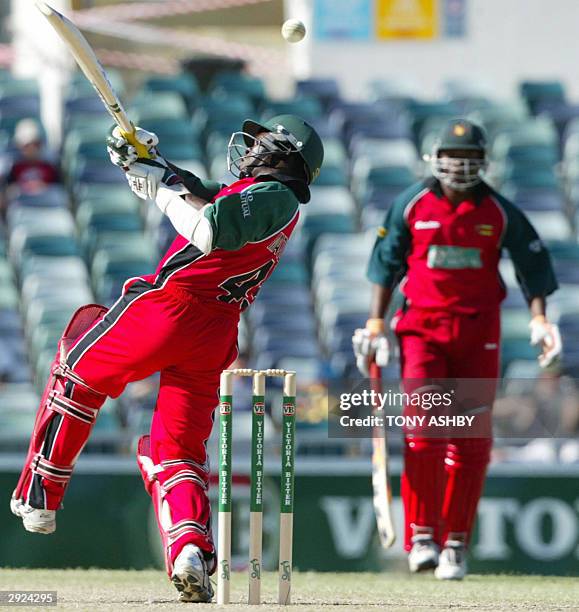 Zimbabwean tailender Stuart Matsikenyeri hooks a ball off Indian fast bowler Irfan Pathan who took four wickets for 24 runs during the VB series one...