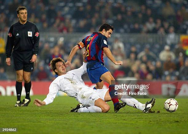 Xavi Hernandez of Barcelona and Mikel of Albacete in action during the La Liga match between FC Barcelona and Albacete played at the Nou Camp...