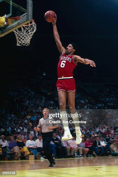 Julius Erving of the Philadelphia 76ers goes for a dunk against the Los Angeles Lakers during a game circa 1986 at the Great Western Forum in...