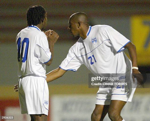 Jerry Palacios of Honduras comforts his teammate Walter Martinez of Honduras after he missed a penalty kick during their Olympic qualifying soccer...
