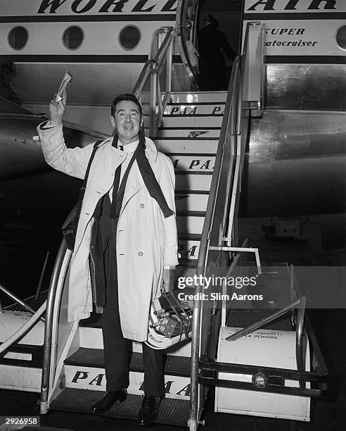 American photographer Slim Aarons arrives on a Pan Am Boeing 377-10-26S Stratocruiser, circa 1955.