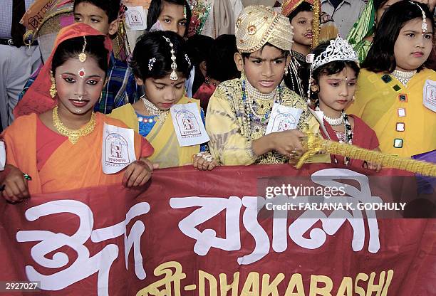 Bangladeshi children dressed in traditional wedding costumes participate in an Eid al-Adha festival procession in Dhaka, 04 February 2004. Hundreds...