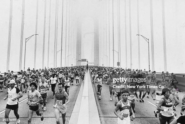 Crowds of runners run across the Verrazano-Narrows Bridge at the beginning of the New York City Marathon, New York City, October 21, 1979.