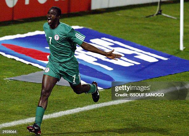 Nigerian forward John Utaka celebrates after scoring his team's second goal against Benin 04 February 2004 in Sfax, during their African Nations Cup...