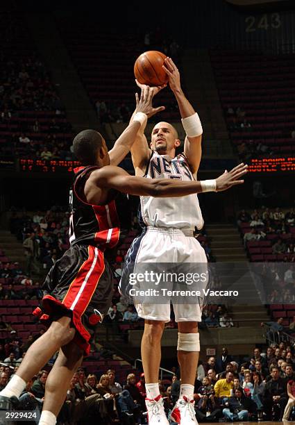 Jason Kidd of the New Jersey Nets shoots against Eddie Jones of the Miami Heat at Continental Airlines Arena February 4, 2004 in East Rutherford, New...